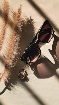 black framed sunglasses on white and black textile